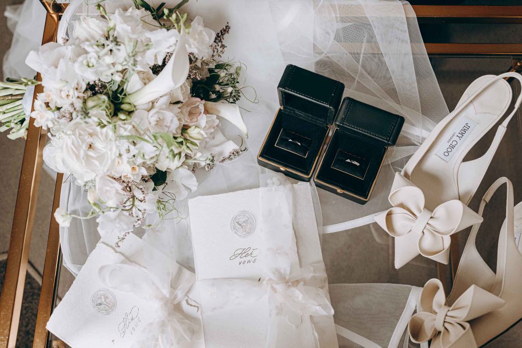Wedding morning details with bouquets, rings, and bridal shoes